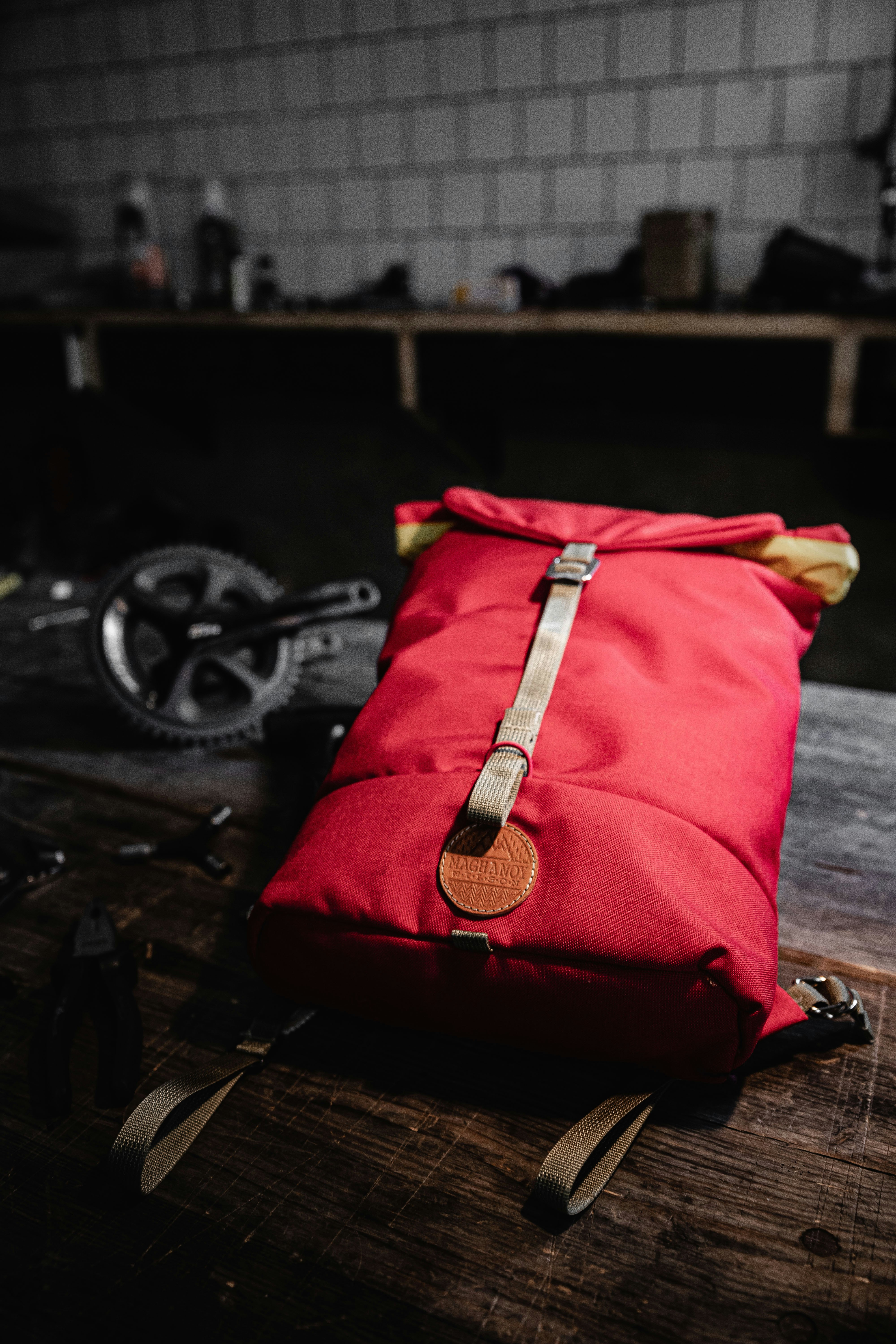 red and black backpack on black wooden table